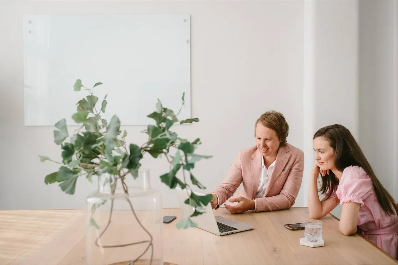 Casey Jones, founder of CJ&CO, in a planning session at a meeting table with a laptop