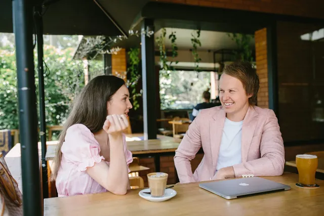 Casey Jones, founder of CJ&CO, talking marketing over coffee at an outdoor cafe