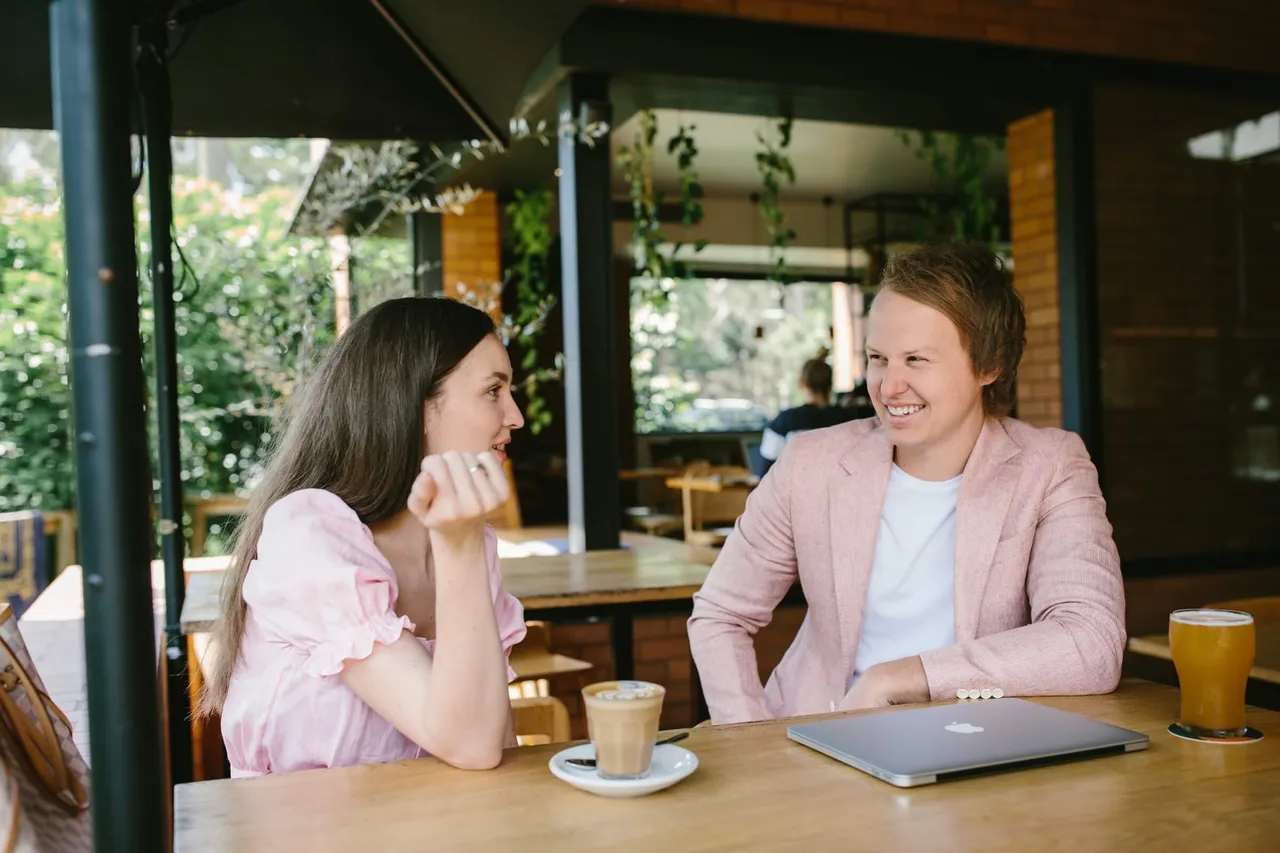 Casey Jones, founder of CJ&CO, talking marketing over coffee at an outdoor cafe