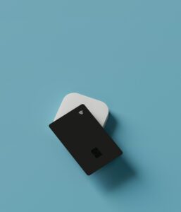 A black card featuring a contactless symbol rests on a white rectangular block against a light blue background, much like pondering whether Amazon has Afterpay for seamless shopping.