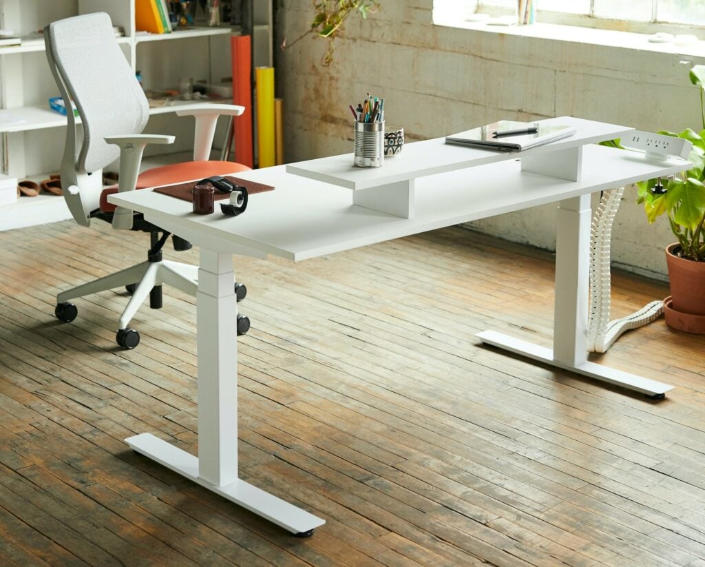 A modern home office, featuring a sleek white desk and chair.