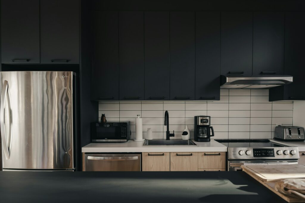 A game-changer kitchen with black cabinets perfect for Airbnb work.