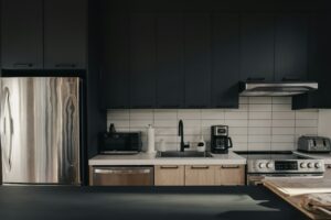 A game-changer kitchen with black cabinets perfect for Airbnb work.