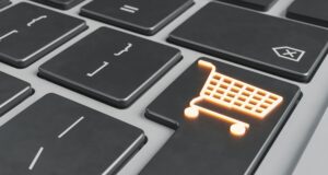 A close-up of a keyboard features an illuminated shopping cart icon on the enter key, symbolizing the efficiency of online shopping. It's as reassuring as knowing how long it takes for Amazon to refund, bringing convenience right to your fingertips.
