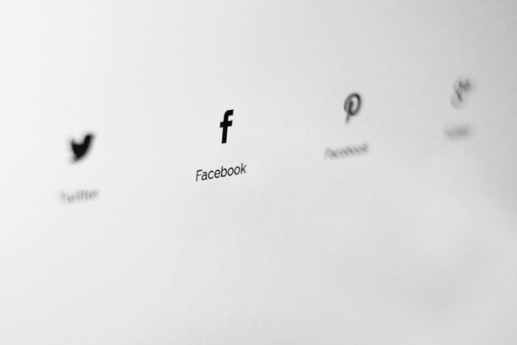 A black and white photo of social media icons showcasing effective Facebook advertising strategies.