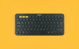 A Logitech keyboard on a yellow background.