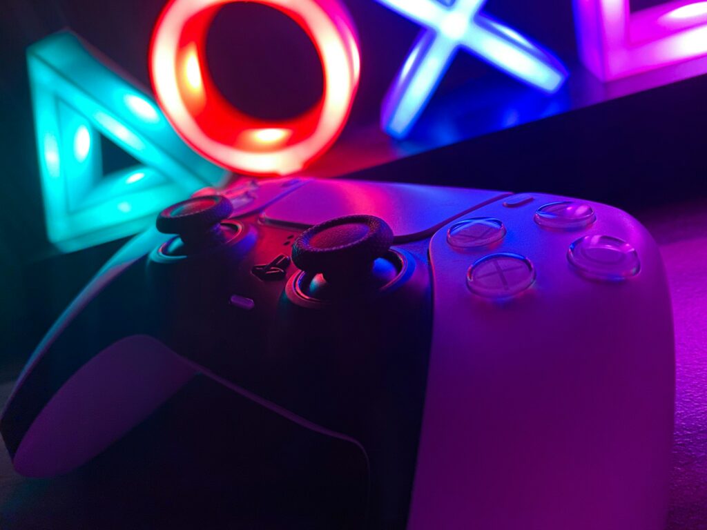 A neon sign illuminated, casting a vibrant glow on a PS4 controller, capturing the attention of passionate gamers.