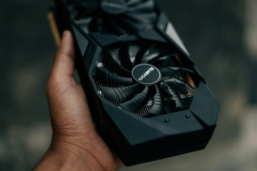 A person holding an ASUS RTX 2080 graphics card, ready to enhance their gaming experience with seamless installation of NVIDIA drivers.