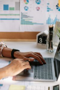 A woman working on a Chrome laptop at a desk.