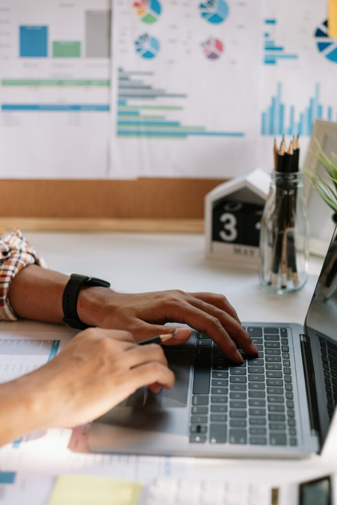 A woman working on a Chrome laptop at a desk.