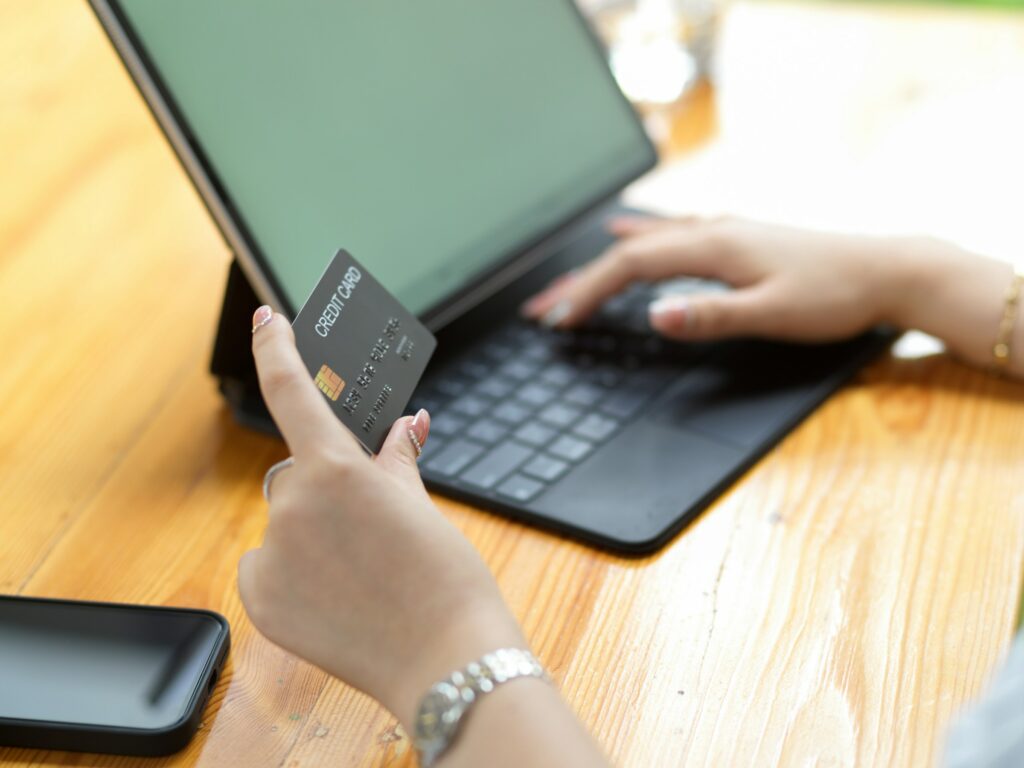 A woman from Australia sending money to India with a credit card on a laptop.