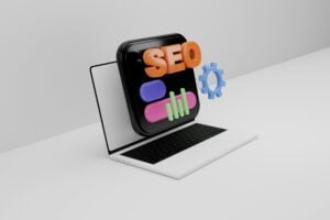 A laptop displaying colorful SEO-related icons, including a magnifying glass, a bar graph, and a gear, indicating search engine optimization concepts. This scene explores whether "keywords and SEO are the same thing.