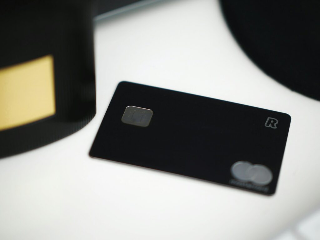 A Secure Black Credit Card Sitting On A Desk.