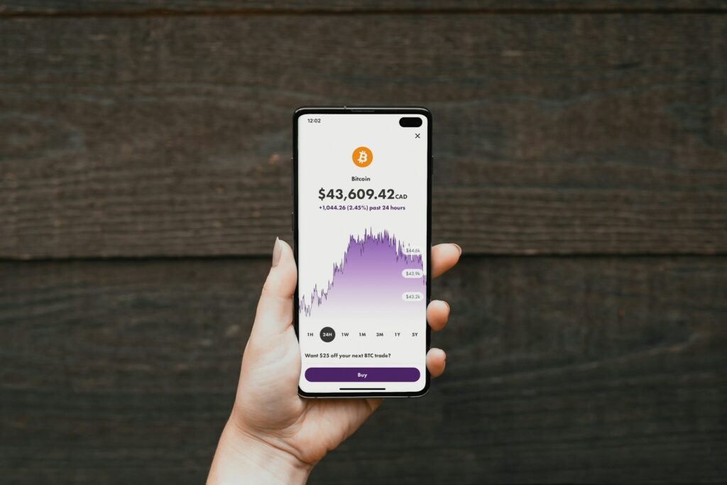 A person showcasing a cryptocurrency app on their phone, exploring potential passive income ideas towards achieving financial freedom.