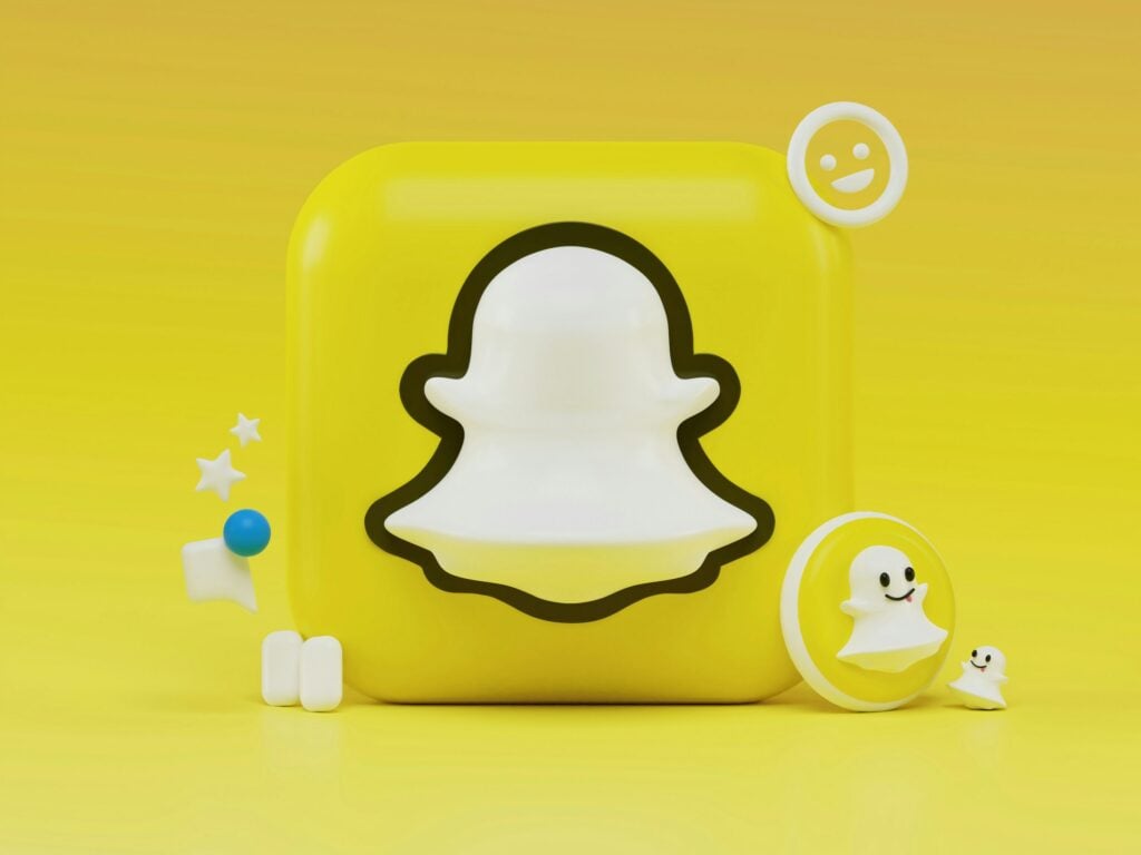 A Snapchat logo on a vibrant yellow background.