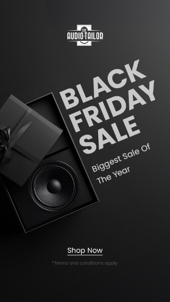 Black Friday sale advertisement for The Audio Tailor featuring a black gift box with a speaker inside, stating "Biggest Sale Of The Year" and a prompt to "Shop Now" with terms and conditions.