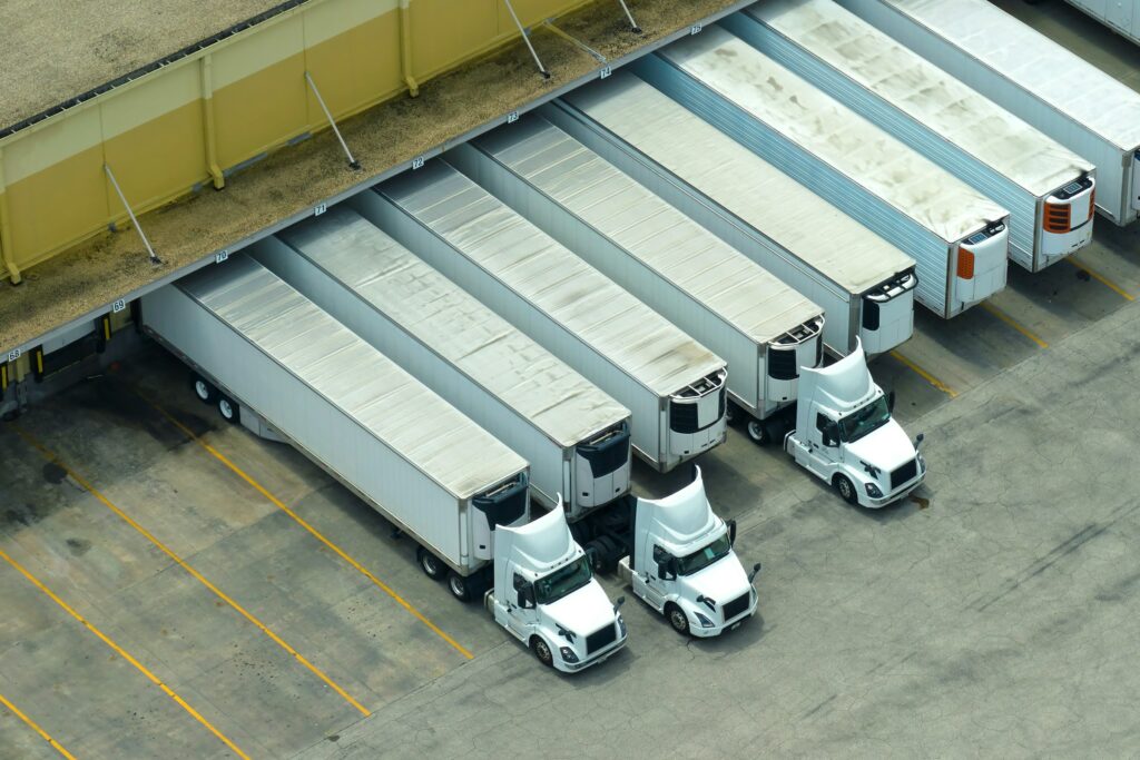 A group of white trucks parked in a parking lot, illustrating the importance of intrastate commerce.