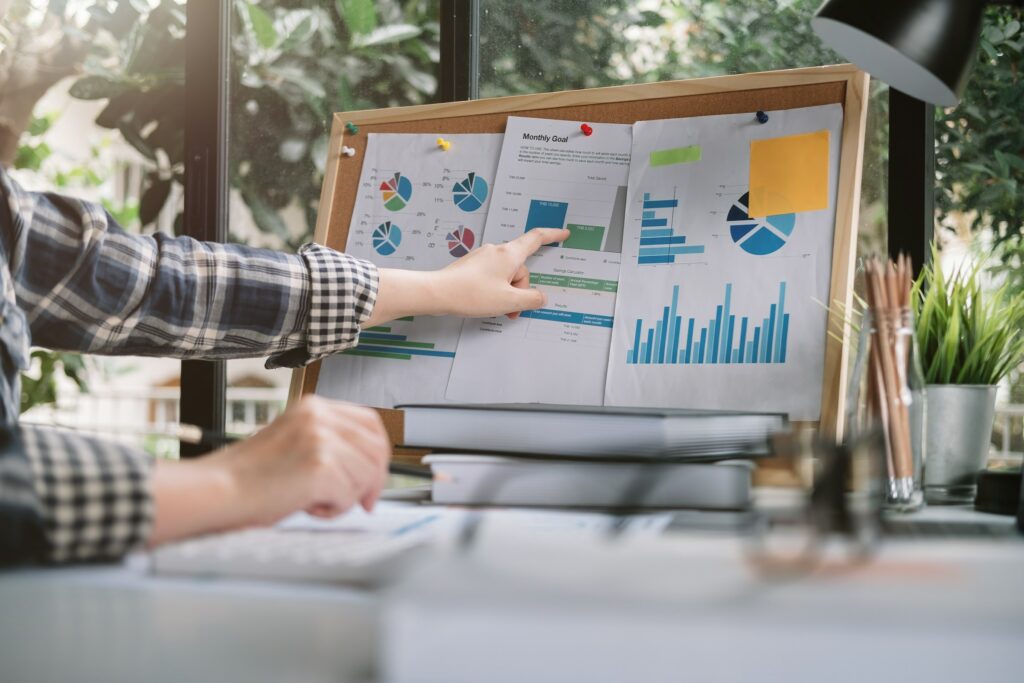 A woman is pointing at graphs on a board, explaining What is On-page SEO.