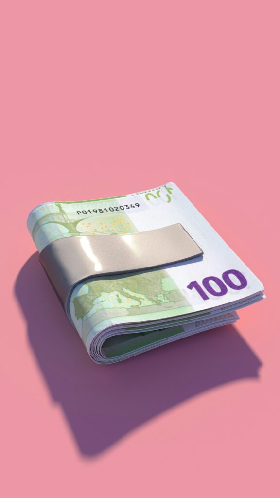 A 100 euro banknote on a pink background for financial planning.