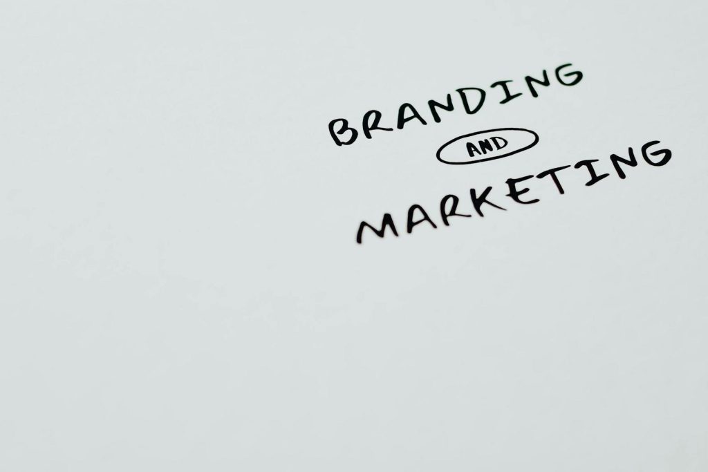 Text on a white background reads "Branding and Marketing" in bold, black letters, with "and" encircled.