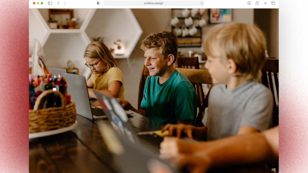 A Group Of Children In Australia Are Sitting At A Table With Laptops, Managing Their Side Hustles.