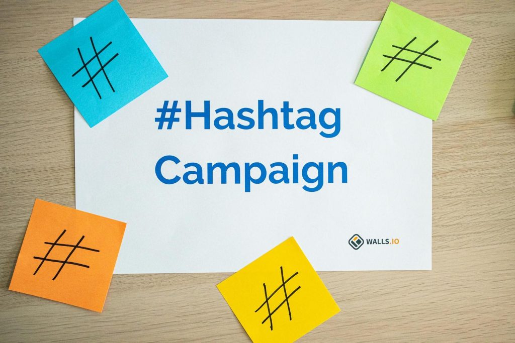 White paper with "#Hashtag Campaign" printed in blue, surrounded by blue, green, orange, and yellow sticky notes, each with a black hashtag symbol.
