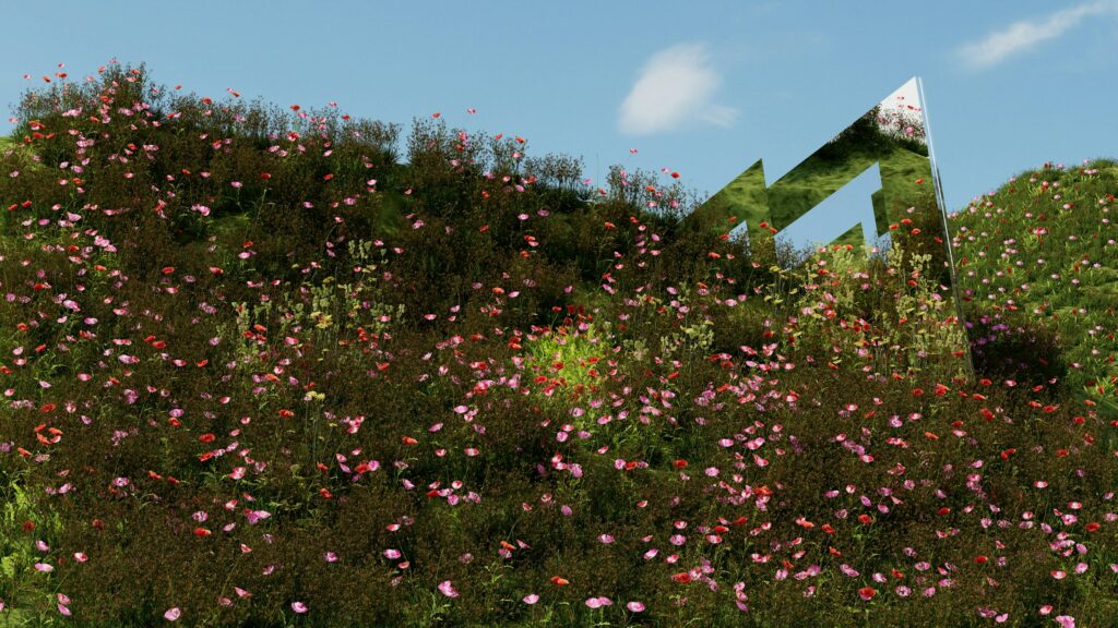 A metal structure is partially hidden by a hillside adorned with pink and red wildflowers, reminiscent of a florist's vibrant display in Perth, all under a clear blue sky.