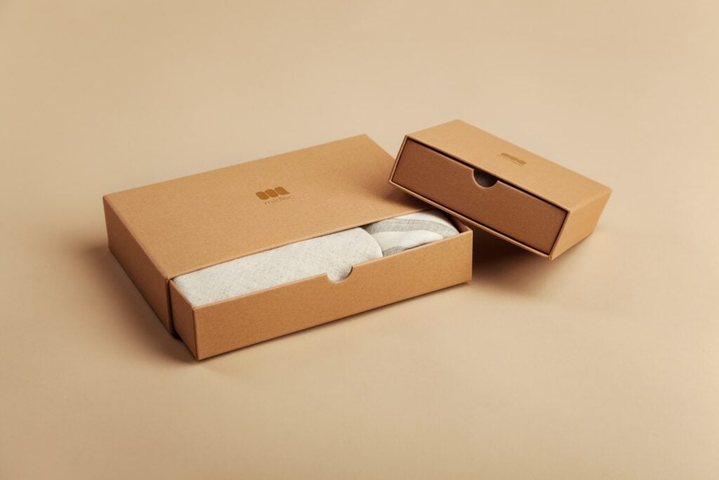 Two cardboard boxes on a beige background, available with free shipping.