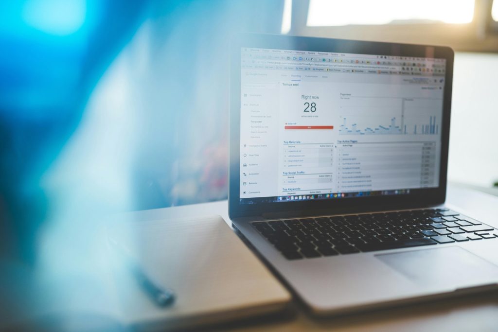 Laptop displaying a Google Analytics dashboard with real-time traffic data, keyword performance charts and metrics — ideal for Google Ads optimisation