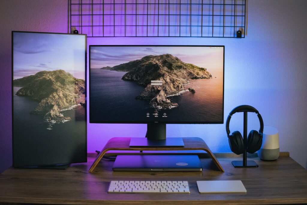 A 2024 Top 10 Home Office Essentials, featuring a desk equipped with a monitor, keyboard, mouse, and headphones.