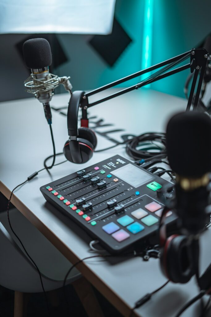 A recording studio with microphones and headphones on a table, perfect for starting a podcast with no audience.