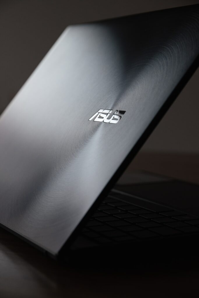 A black laptop with the ASUS logo.