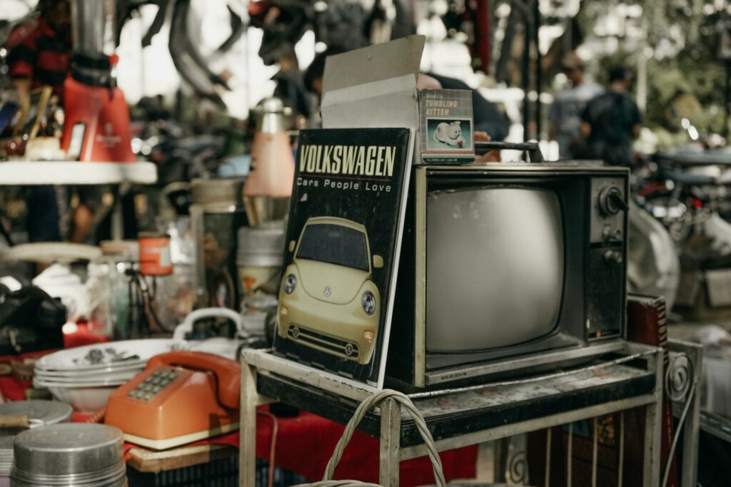An old television sits on a table in an online marketplace.