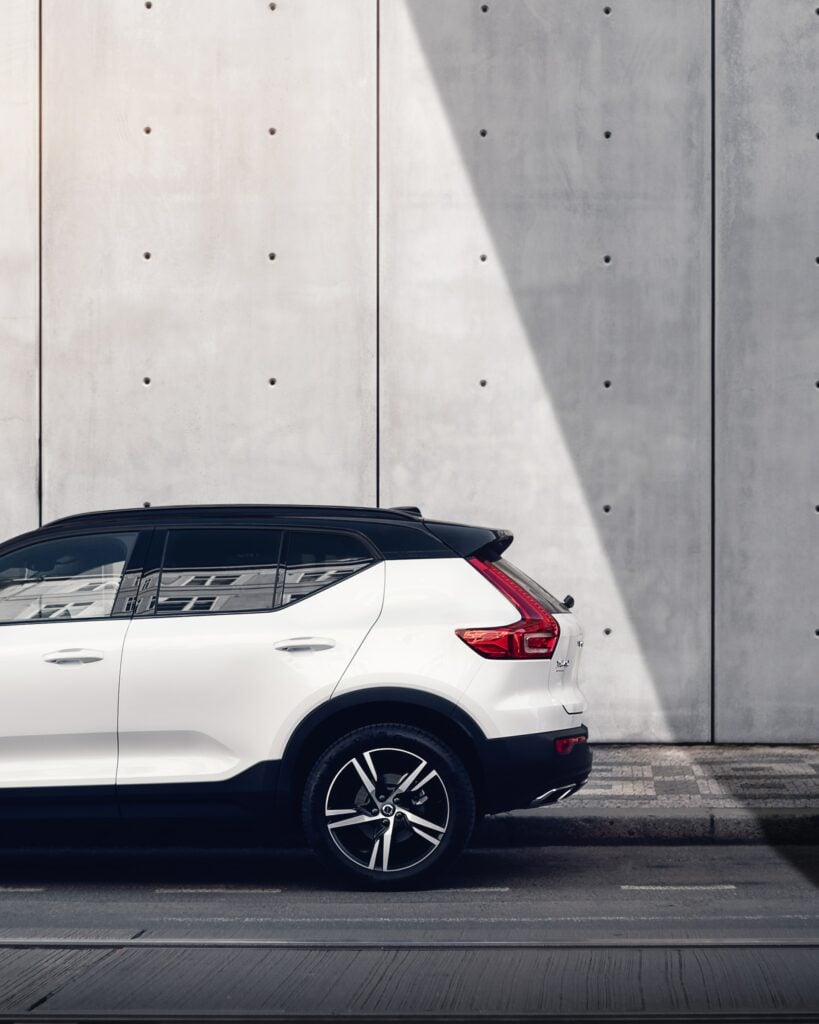 The 2019 Volvo XC90 SUV, a luxury brand, is parked in front of a concrete wall.