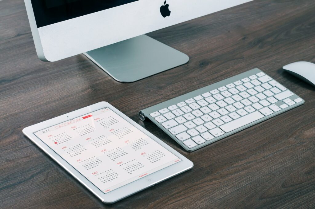 An ipad on a desk next to a keyboard and mouse, showcasing Martech revolutionizing digital marketing and business optimization.