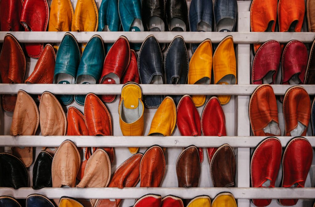 Colorful shoes lined up on a shelf, showcasing innovative text-to-image technology.