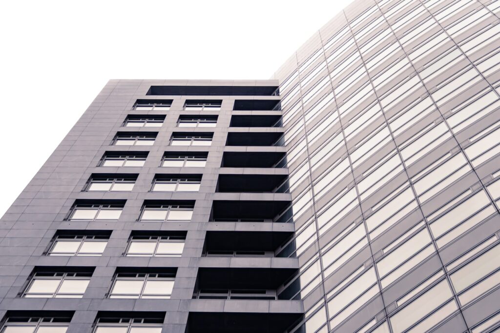 A revolutionary tall building with many windows.