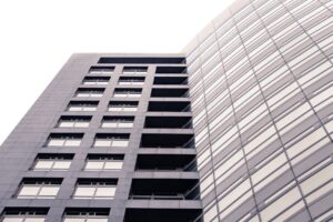 A revolutionary tall building with many windows.
