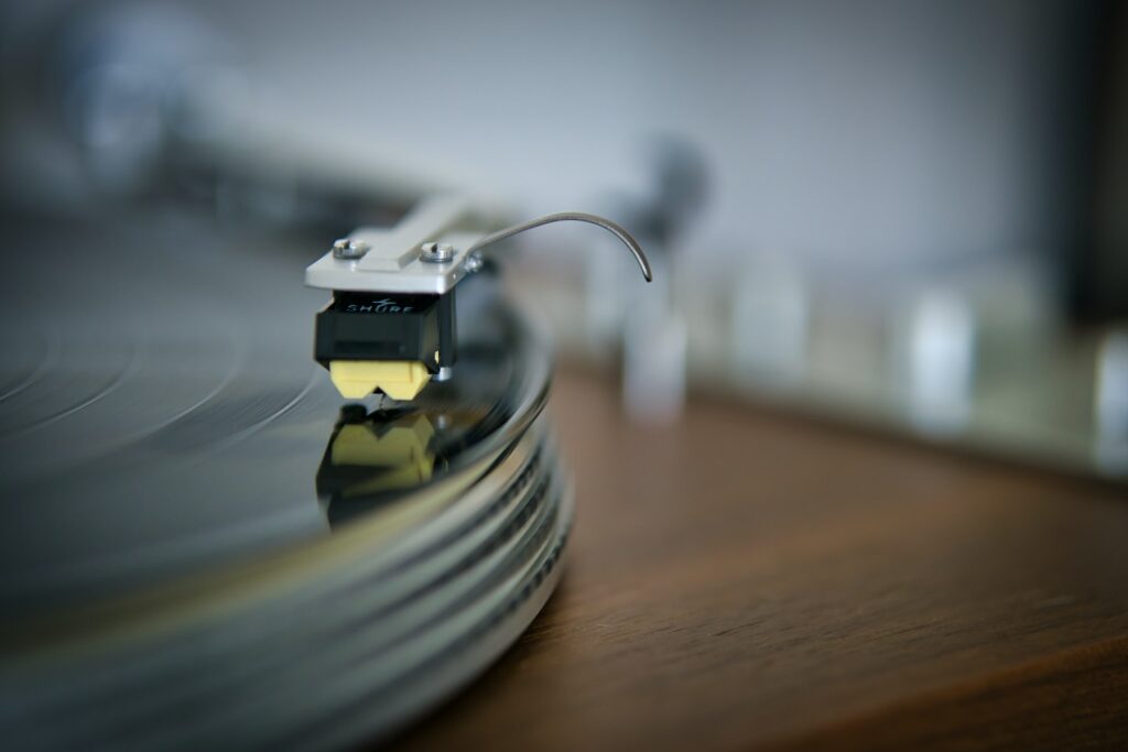Introducing AudioLDM 2, a close up of a turntable on a wooden table.