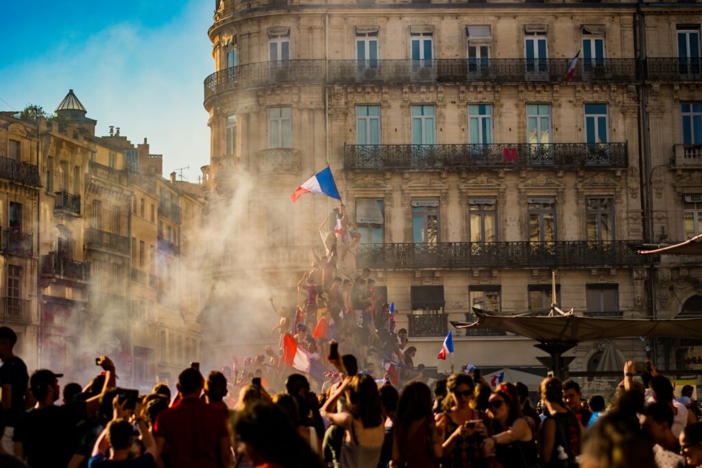 A crowd watching fireworks in a city.