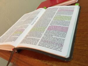 A desk showcasing an open bible using advanced semantic analysis.