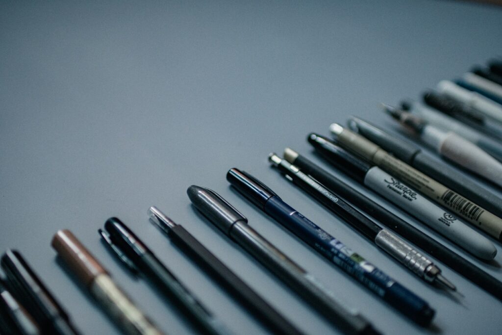 A group of pens are lined up on a table, showcasing effective content writing.