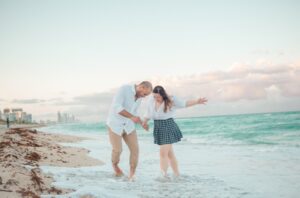 A couple walking on the beach at sunset, unlocking the power of email marketing with 10 must-know copywriting tactics.