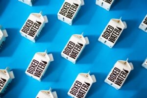 A collection of milk cartons on a blue surface, showcasing product differentiation for business success.
