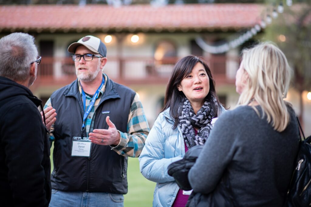 A group nurturing customer relationships in front of a building.