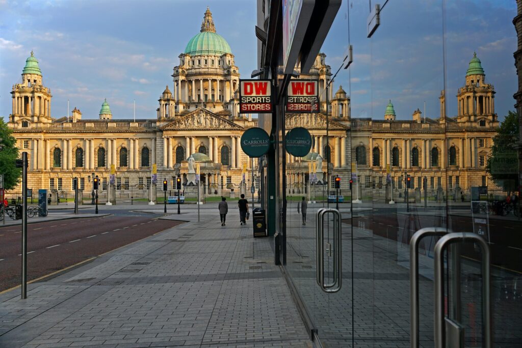 A glass window reflects a large building.