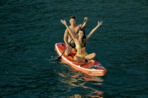 Two people on a paddle board in the water, exploring the advancements in language modelling and NLP.
