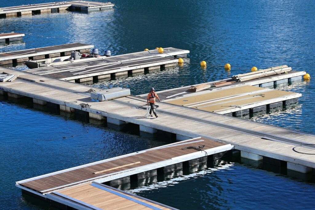 A man cycling on a dock with an SEO magazine in hand.