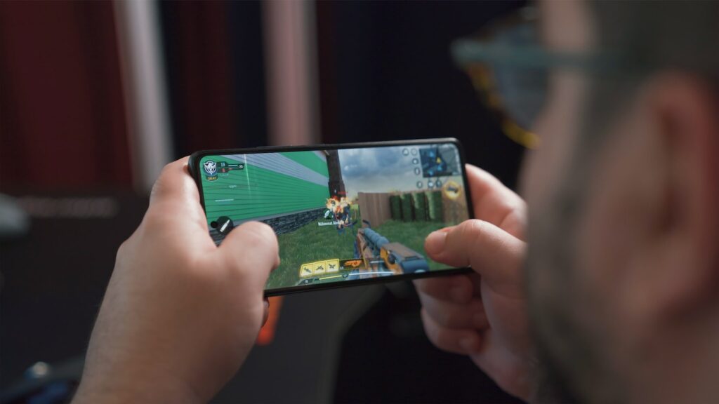 A man is using his phone to play a game.