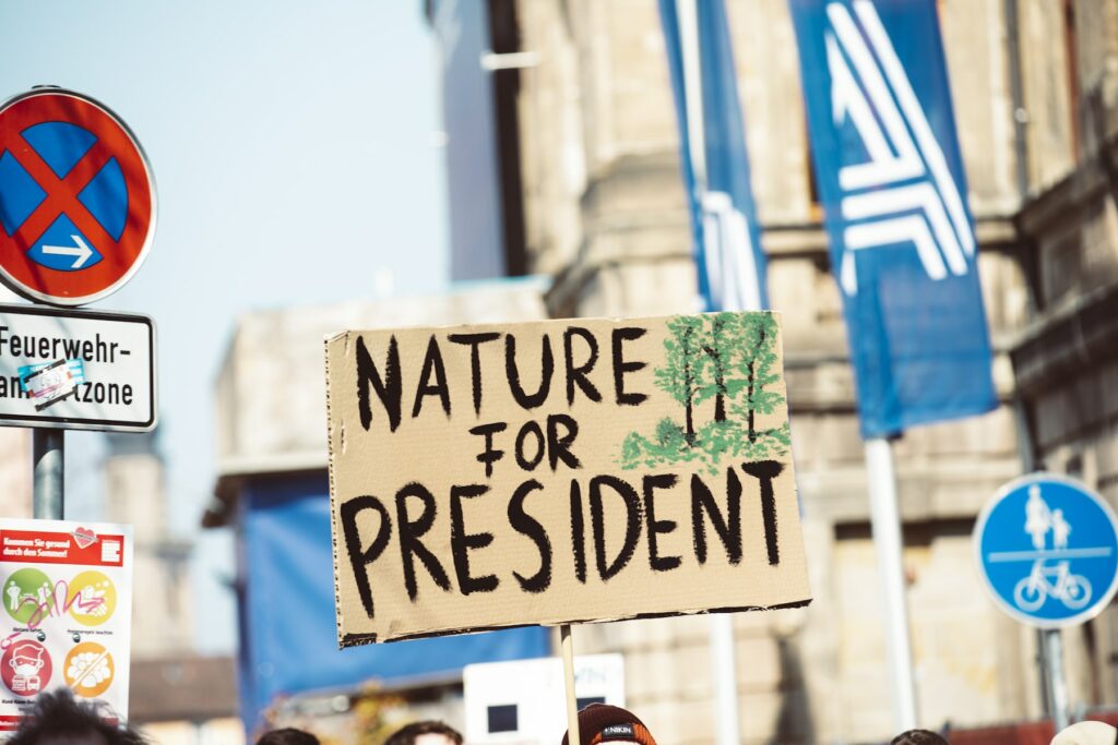 A man holding a sign that says nature for president, embracing SEO trends and generative AI for successful content creation in 2024.